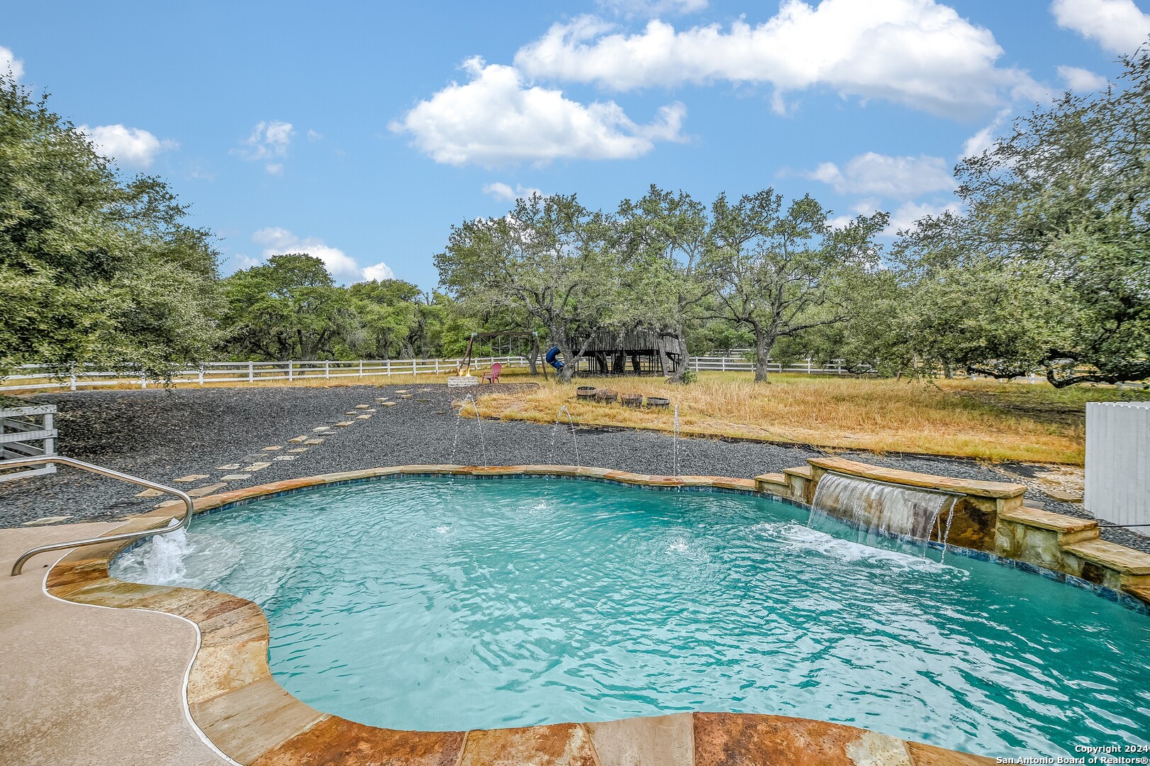 a view of a swimming pool with an outdoor seating and a yard