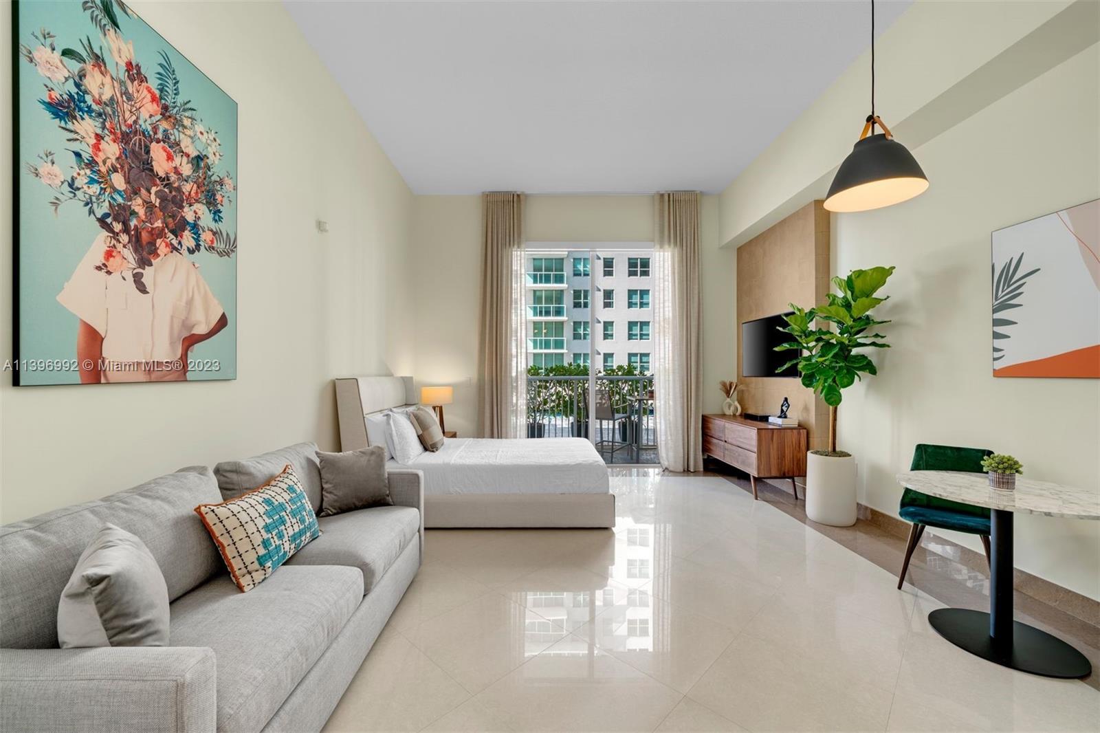 a living room with furniture and a potted plant