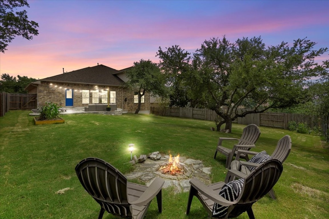 a front view of a house with garden and a patio