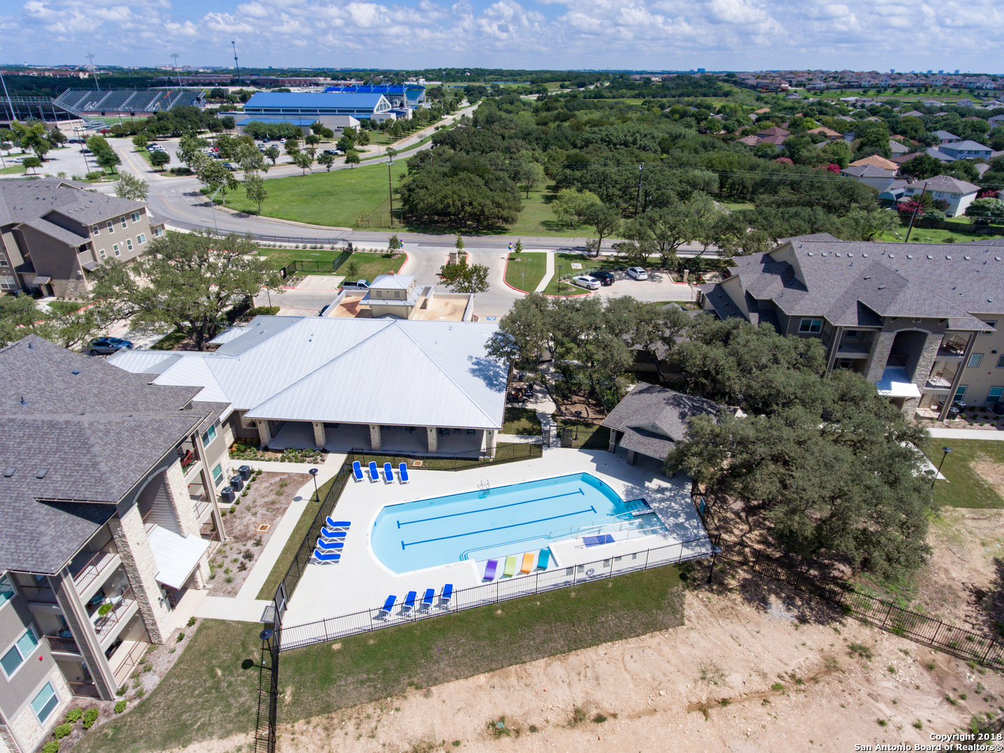 an aerial view of a house with a garden and lake view