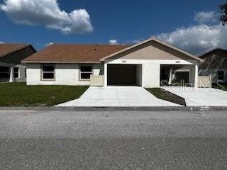 a view of house with yard in front of it