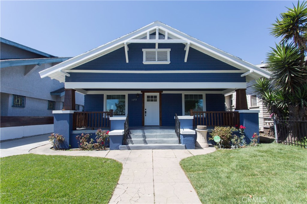 a front view of house with yard and outdoor seating