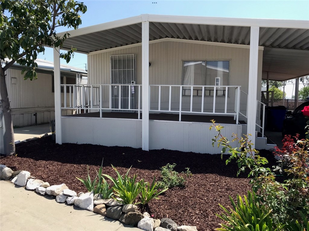 a front view of a house with a yard and a garden