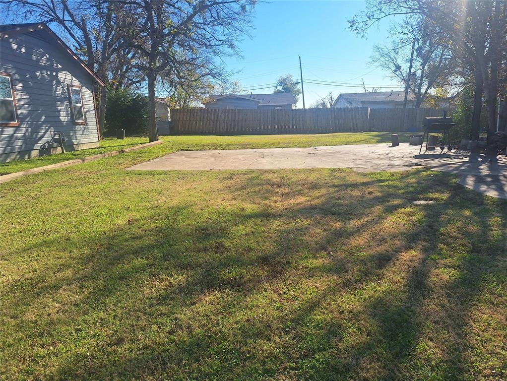 a view of a yard with a large tree