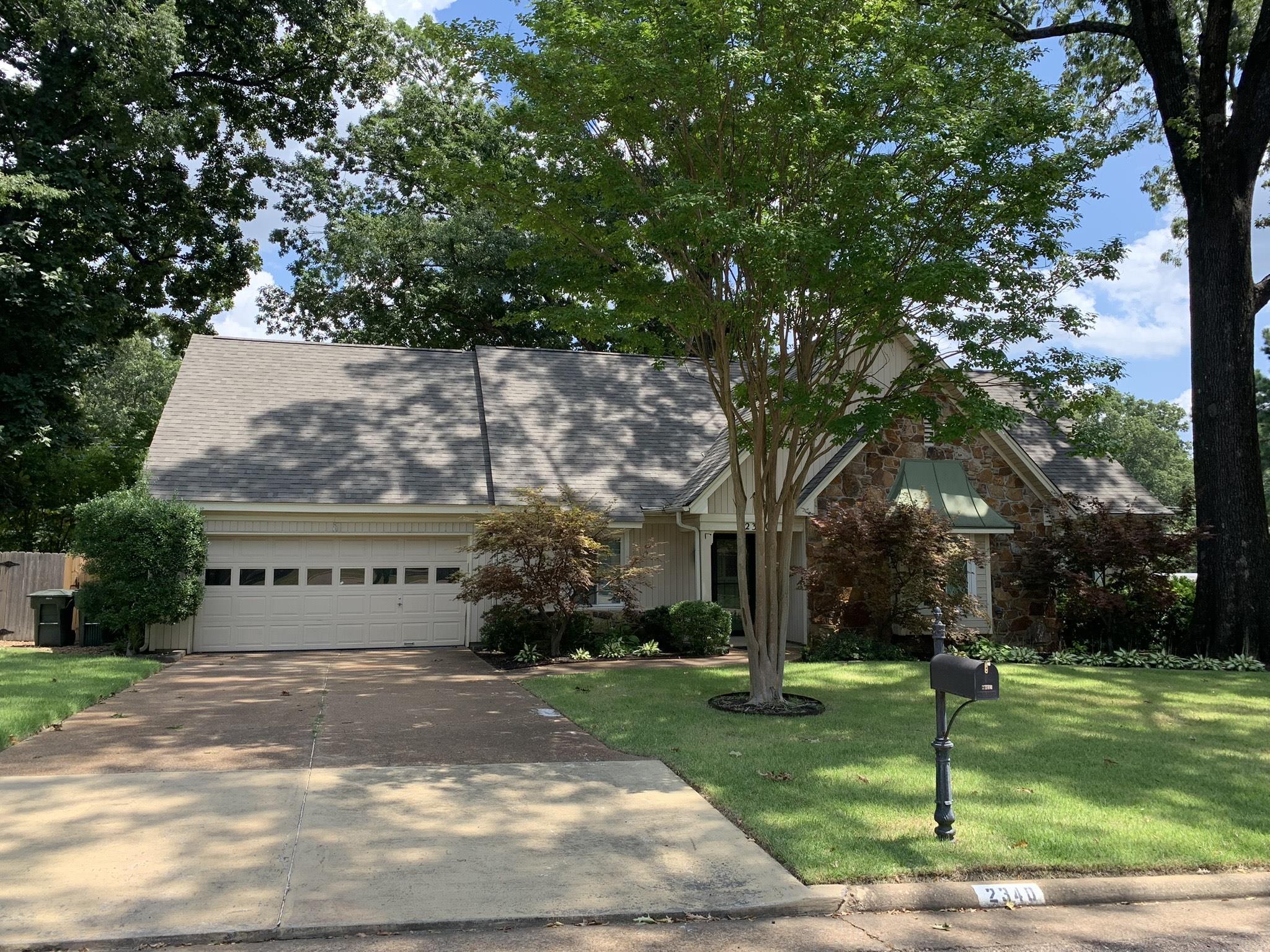 View of front facade with a garage and a front lawn