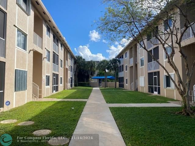 a view of a building with a yard