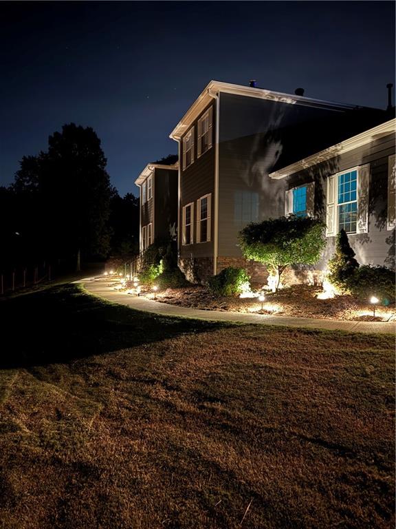 a view of a house with backyard water fountain and sitting area