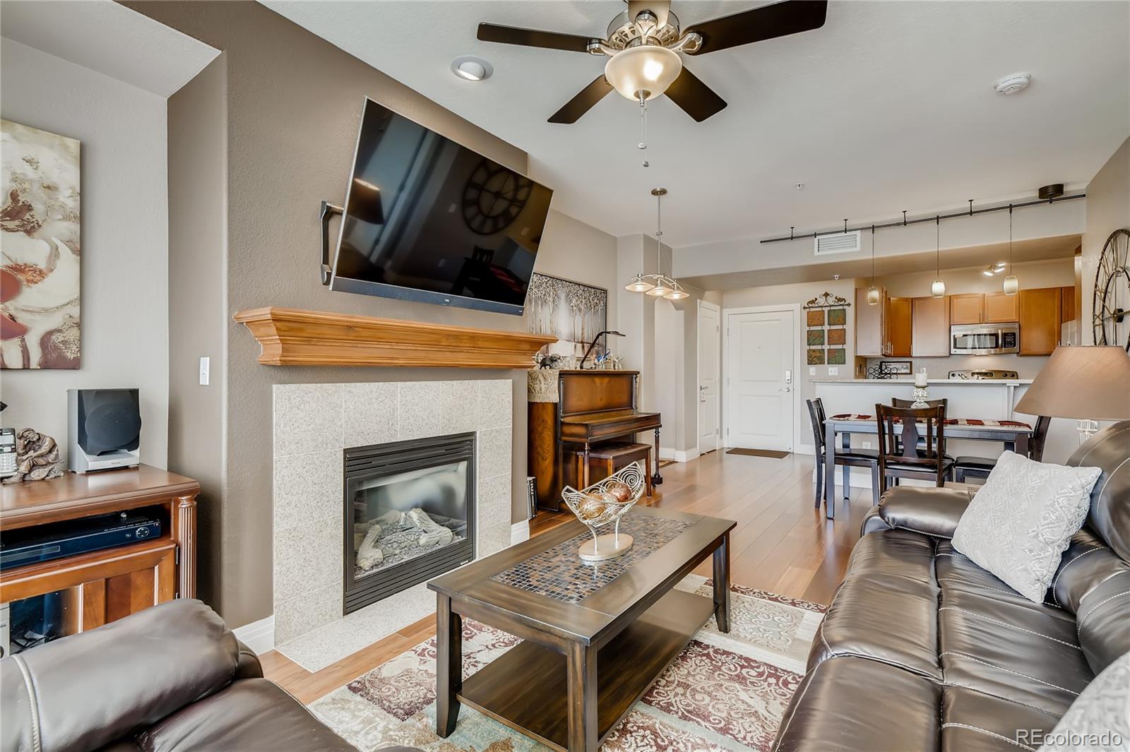 a living room with furniture a flat screen tv and a fireplace