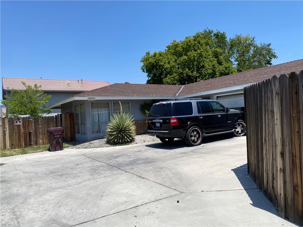 a view of a car parked in front of a house