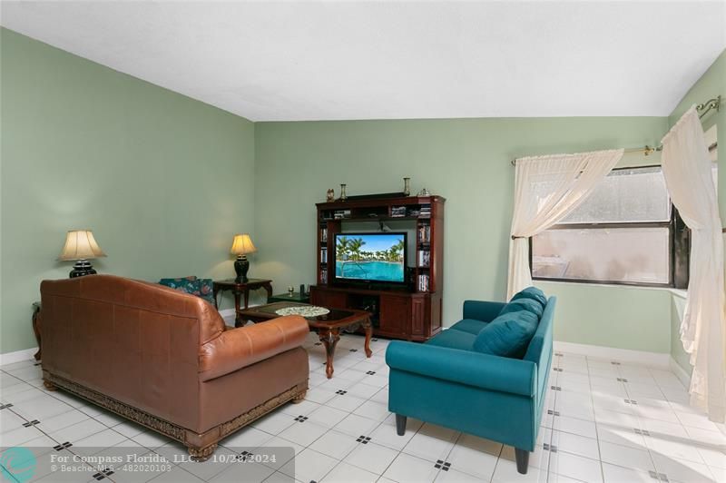 a living room with furniture and a lamp