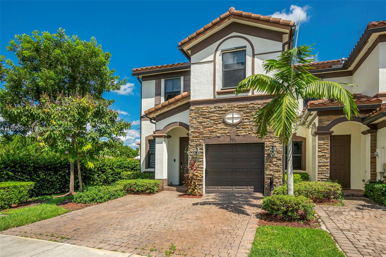 a front view of a house with garden