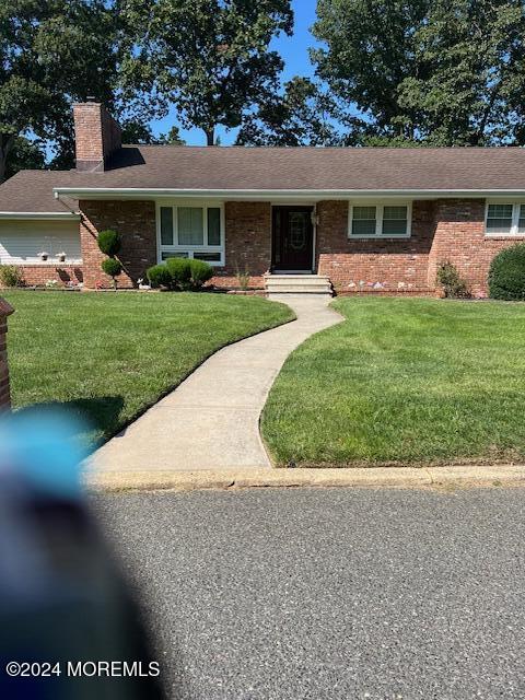 a front view of house with yard and green space