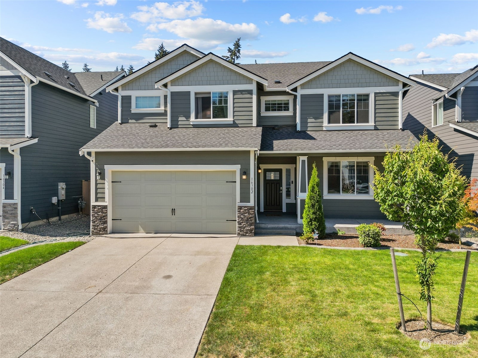 a front view of a house with a yard and garage