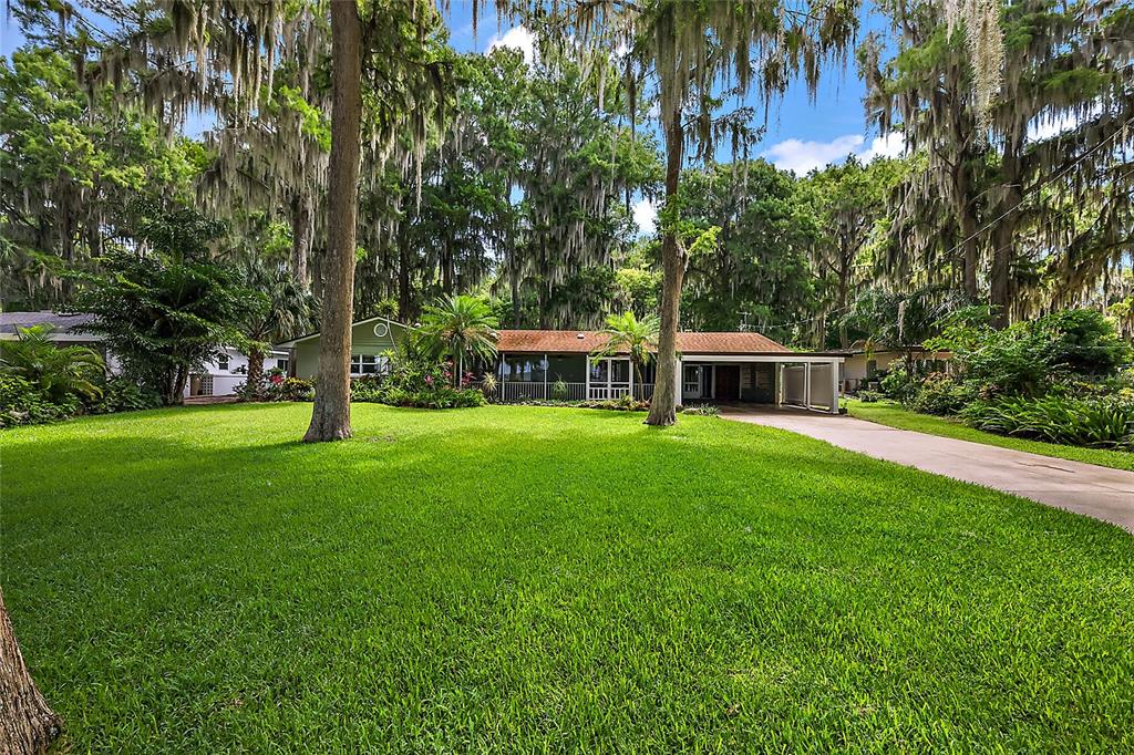 a front view of house with yard and green space