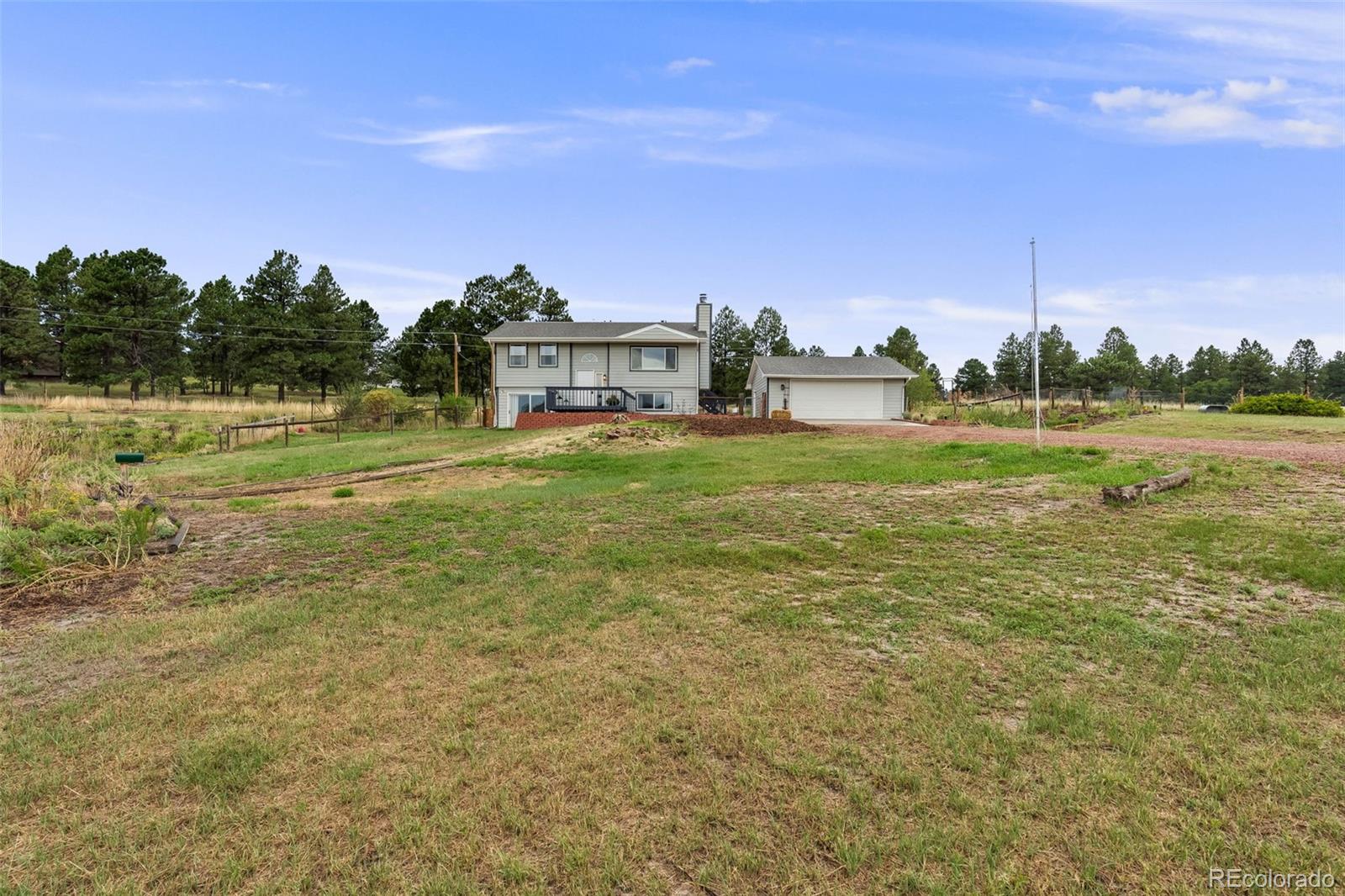 a view of a big yard with a house in the background