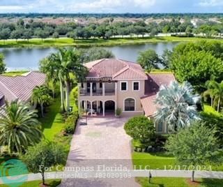 an aerial view of a house with garden space and a lake view