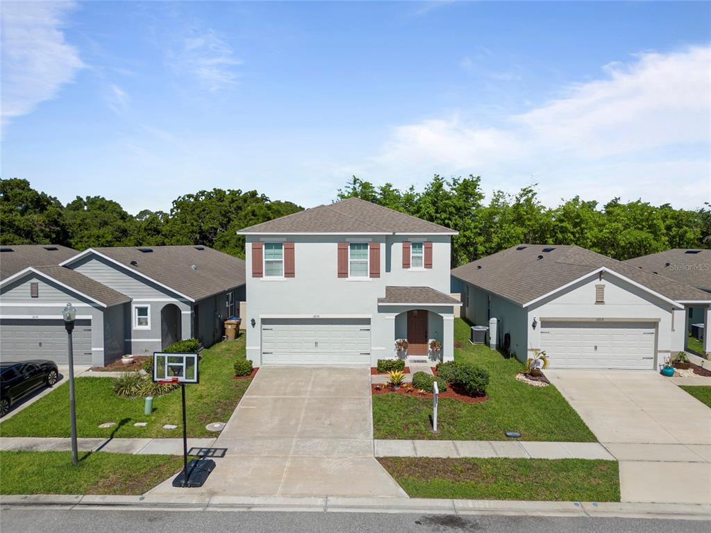 a front view of a house with a yard