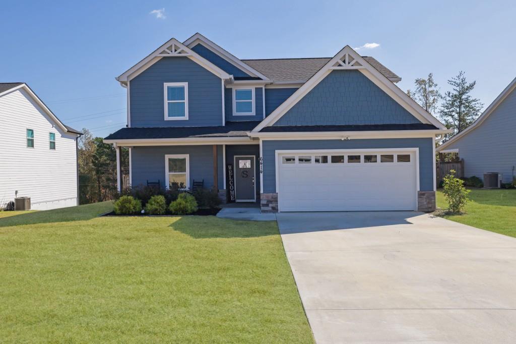 a front view of a house with a yard and garage