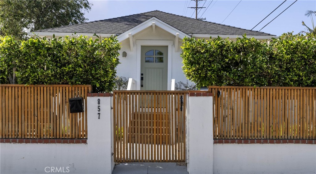 a view of a house with a small yard and plants