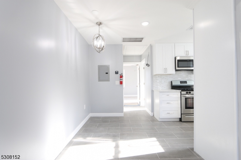 a view of kitchen with refrigerator and window