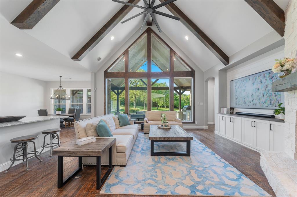 a living room with furniture a fireplace and a large window