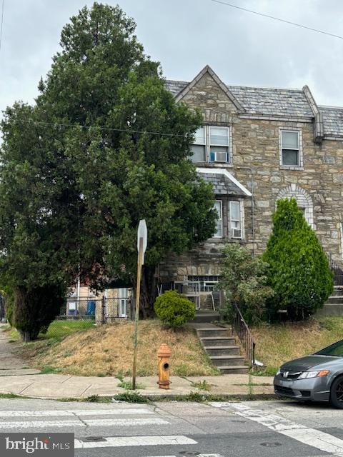 a front view of a house with a garden