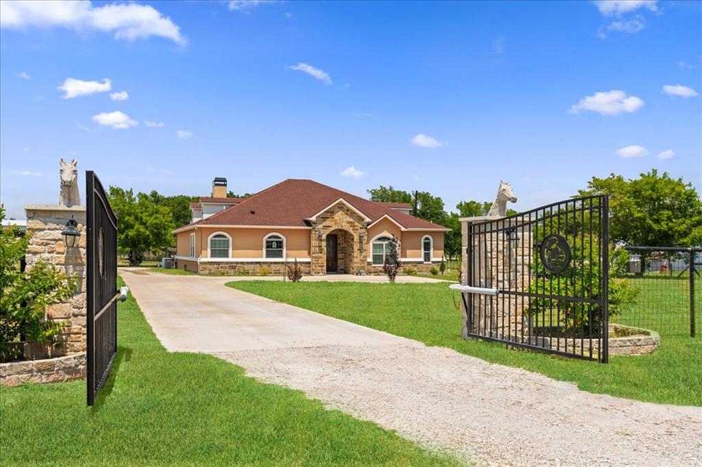 a view of a garden with a small yard and wooden fence