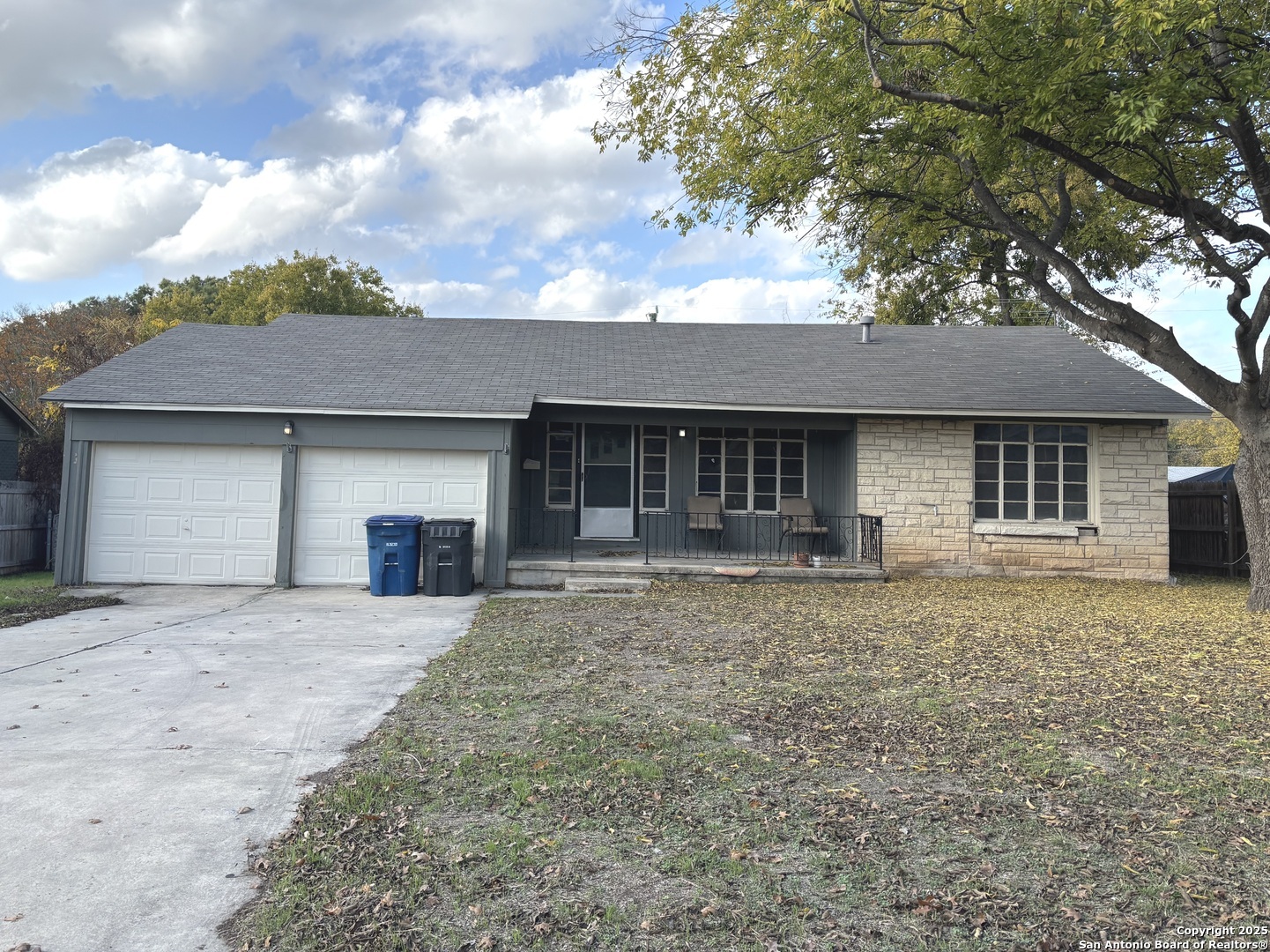 a front view of a house with a garden and yard