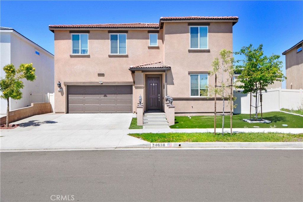 a house with a yard and a large parking space