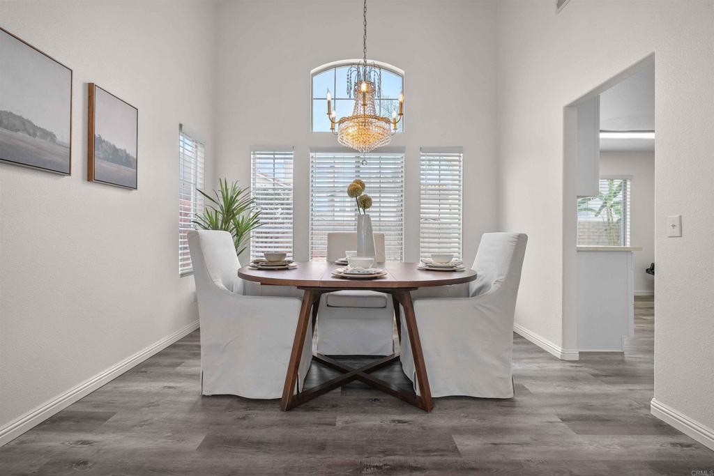 a dining room with wooden floor and a window