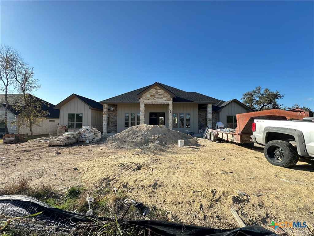 a front view of a house with cars parked