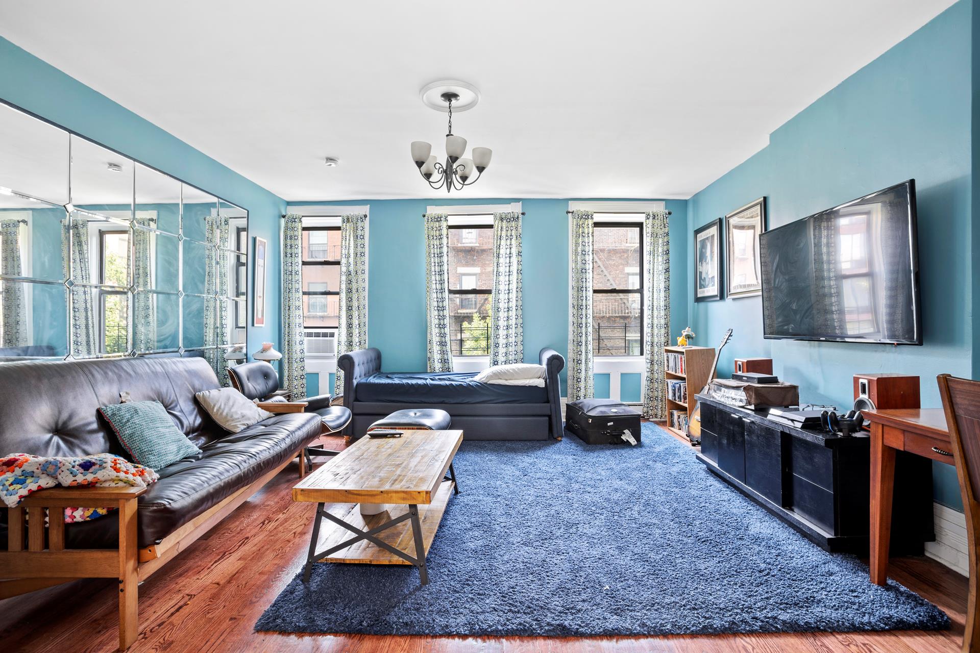 a living room with furniture and a flat screen tv