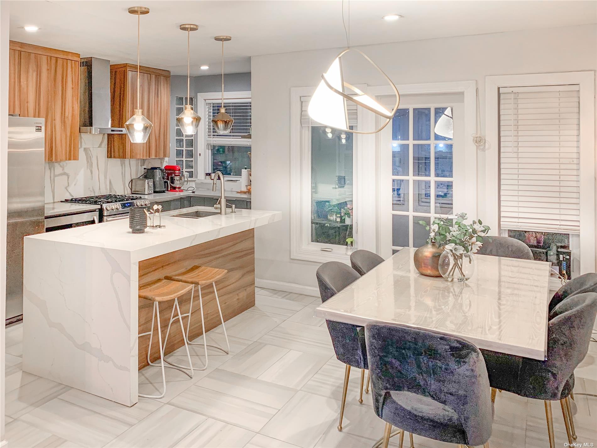 a kitchen with a stove a sink a dining table and chairs