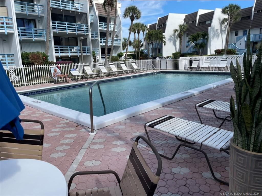 a view of a swimming pool with outdoor seating