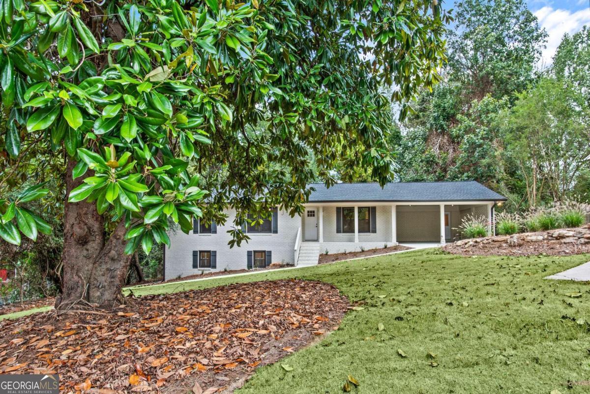 a front view of a house with a garden