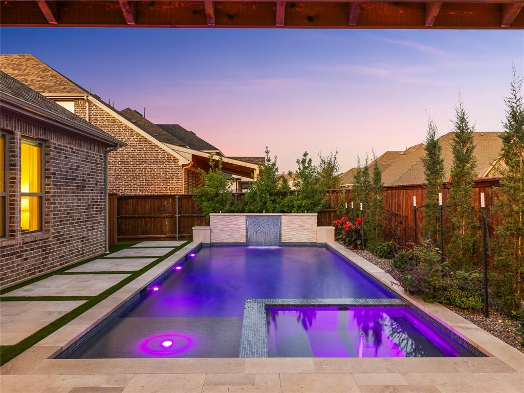 a view of swimming pool with red chairs