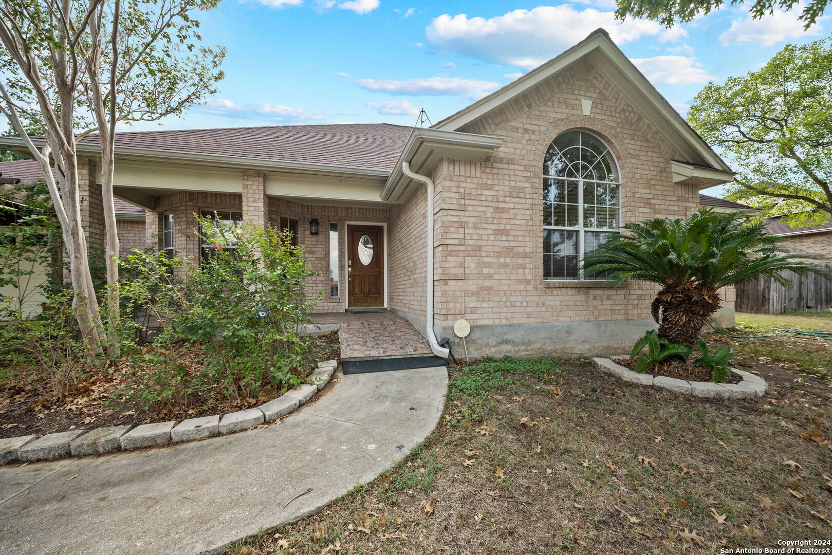 a front view of a house with garden