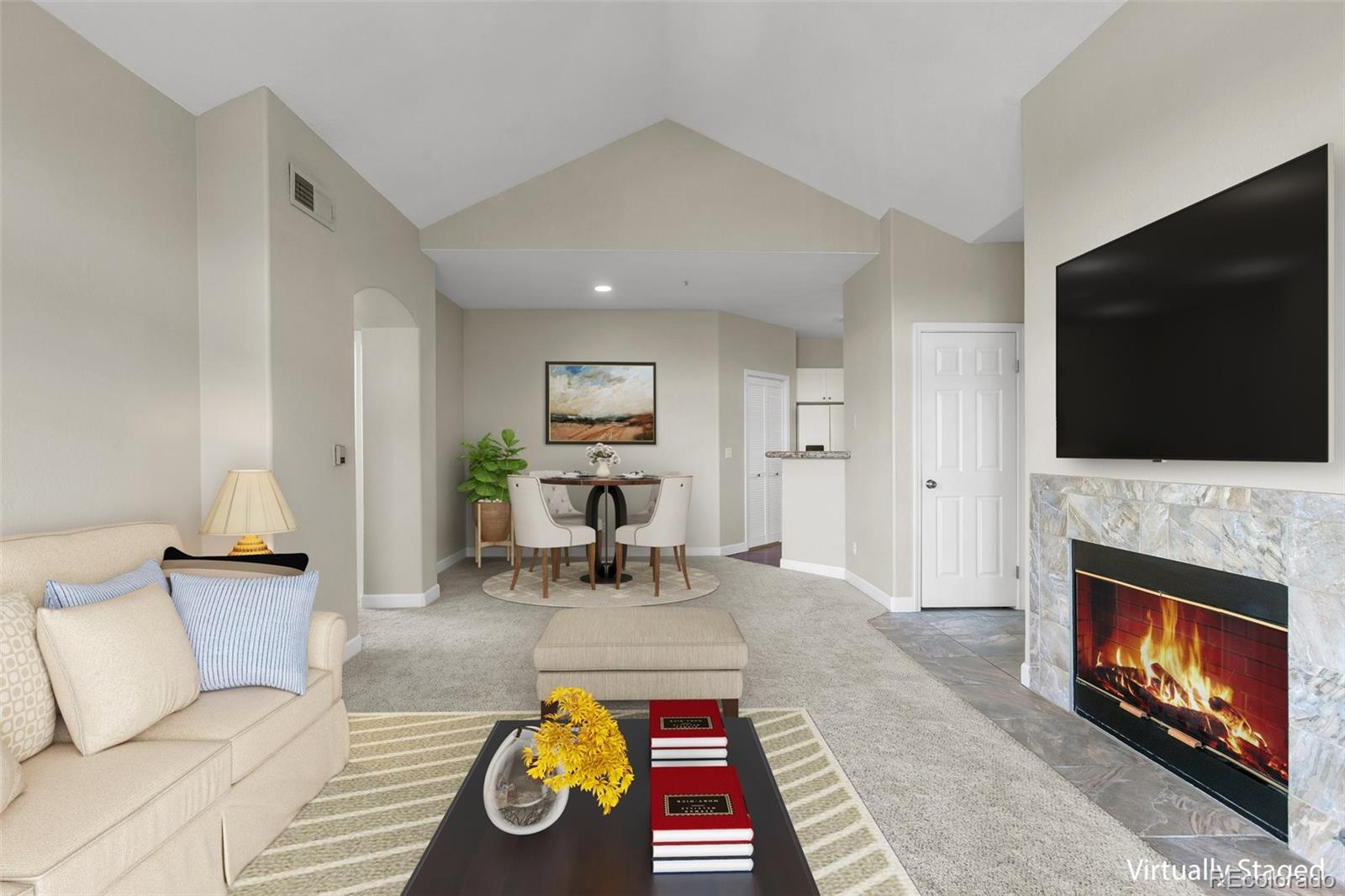 a living room with furniture fireplace and flat screen tv