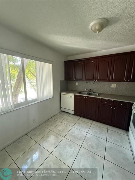 a kitchen with a cabinets and window