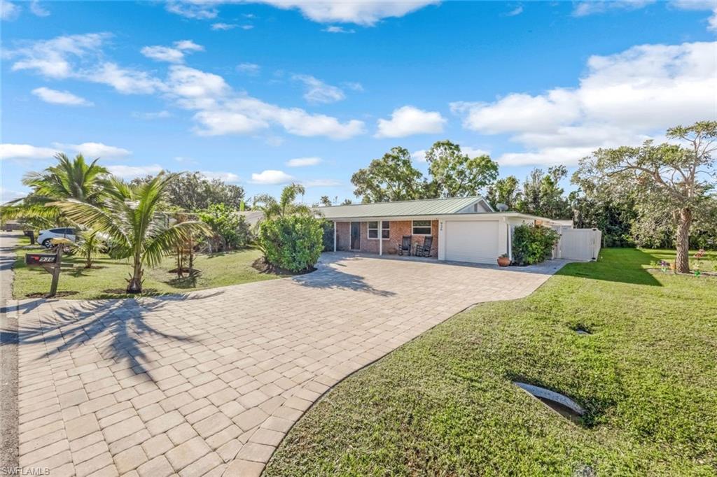 Ranch-style home with a front yard and a garage