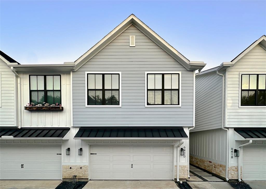 a view of a house with a garage and windows