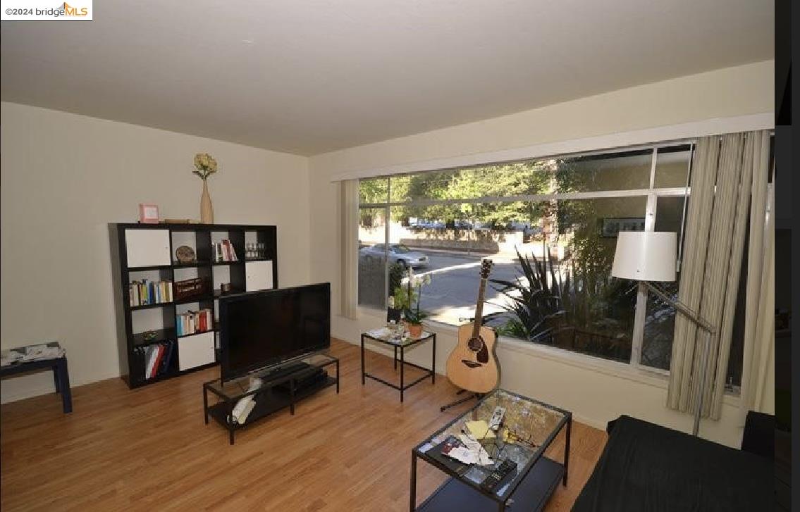 a living room with furniture a rug and a floor to ceiling window