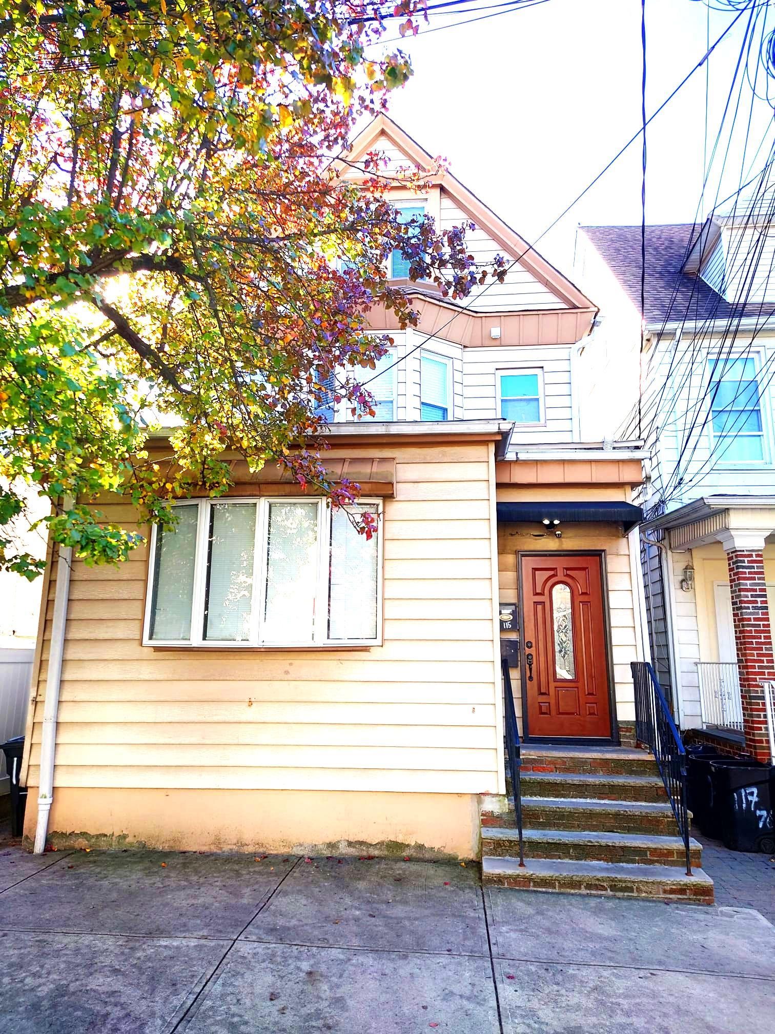 a view of front door of house with stairs