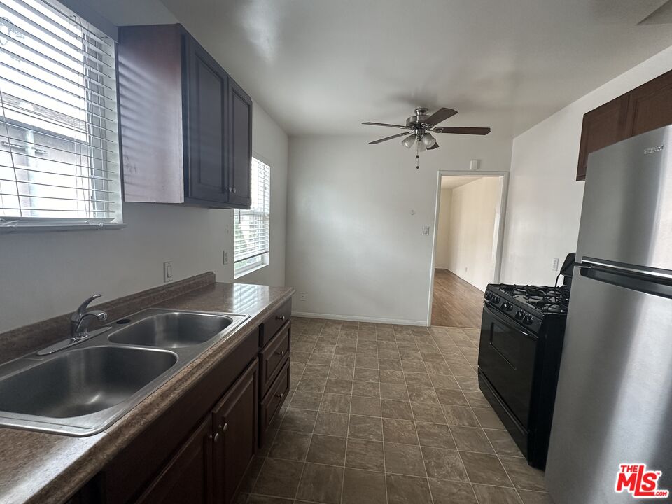 a kitchen that has a sink a refrigerator and window