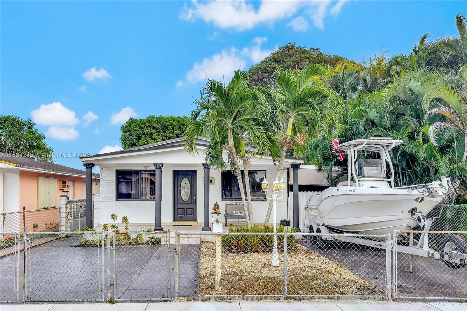 a front view of a house with garden and patio