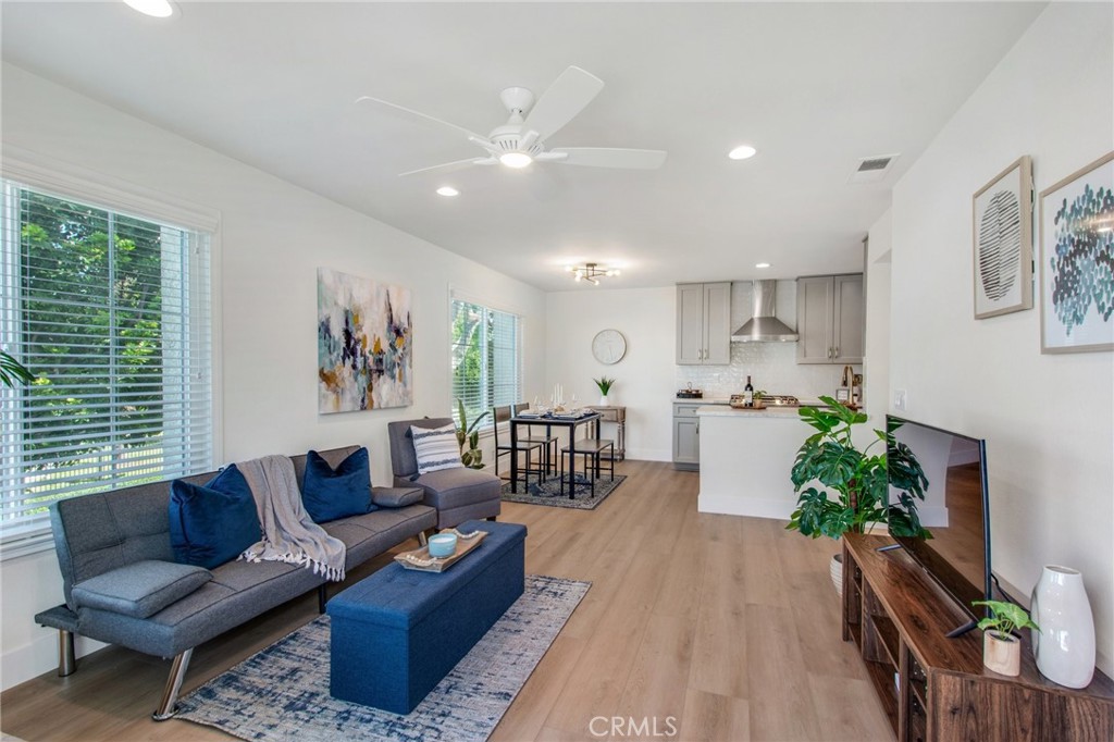 Living room view from entry, including warm vinyl plank flooring.