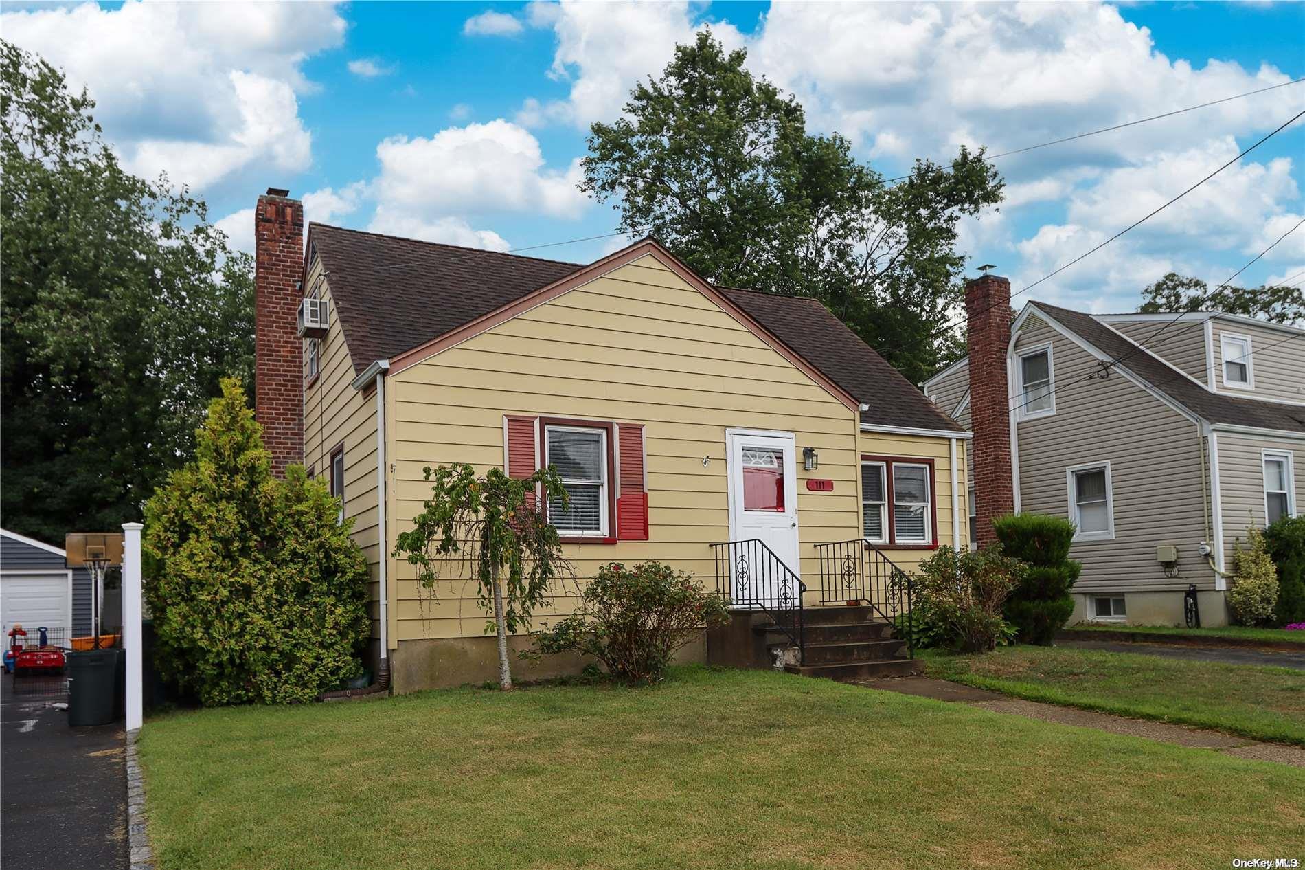 a front view of house with yard and green space