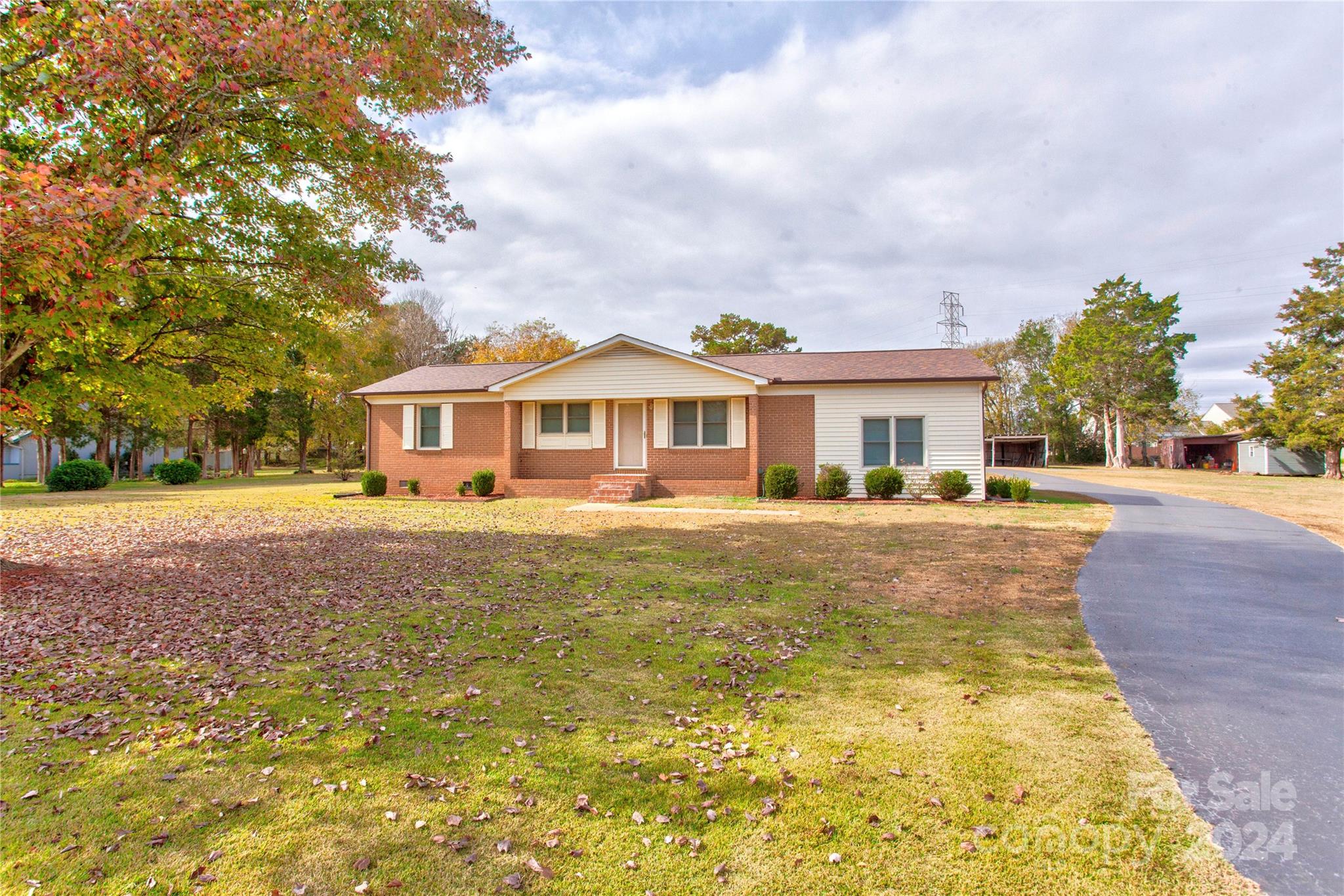 a front view of house with yard swimming pool and green space