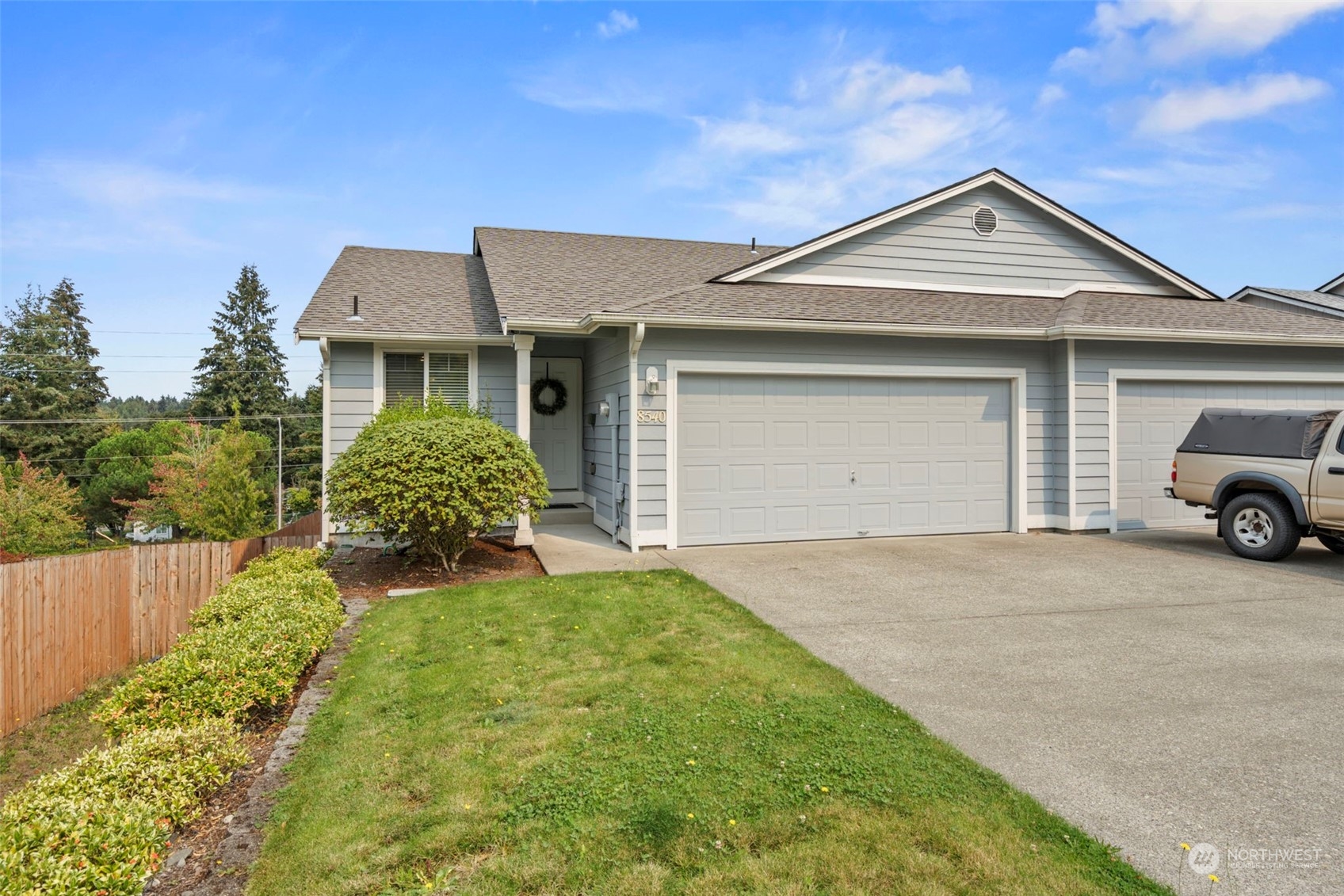 a front view of a house with a yard and garage