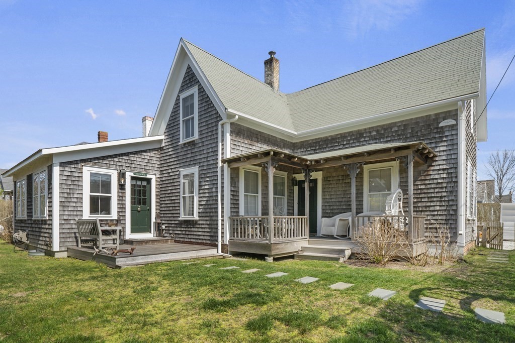 a view of a house with a backyard and a patio